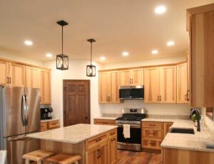 Modern and rustic pine kitchen with overhead can lights and accent lighting installed by Wisconsin electricians at E-Con Electric