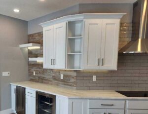 Modern farm house kitchen with overhead can lights and accent shelf lighting installed by Wisconsin electricians at E-Con Electric